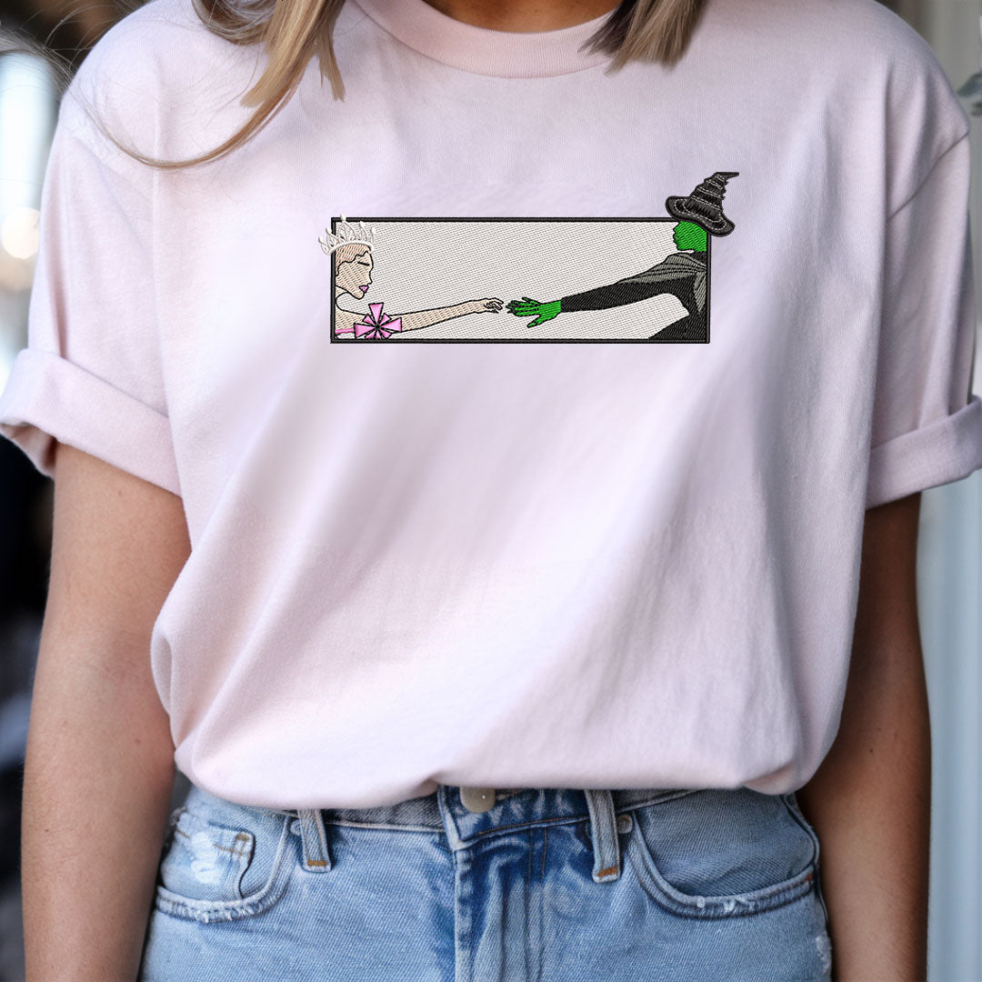 Wicked Glinda and Elphaba Hand Embroidery Sweatshirt – Colorful Defy Gravity Broomstick Magic Wand Design, Wizard of Oz Witch Sweatshirt, Pink and Green Tee, Perfect Gift